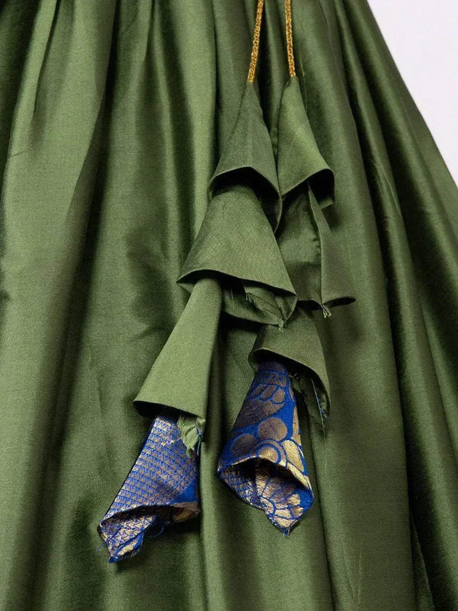 Olive green ethnic gown with blue gold brocade ruffle detailing, perfect for Indian festive wear.