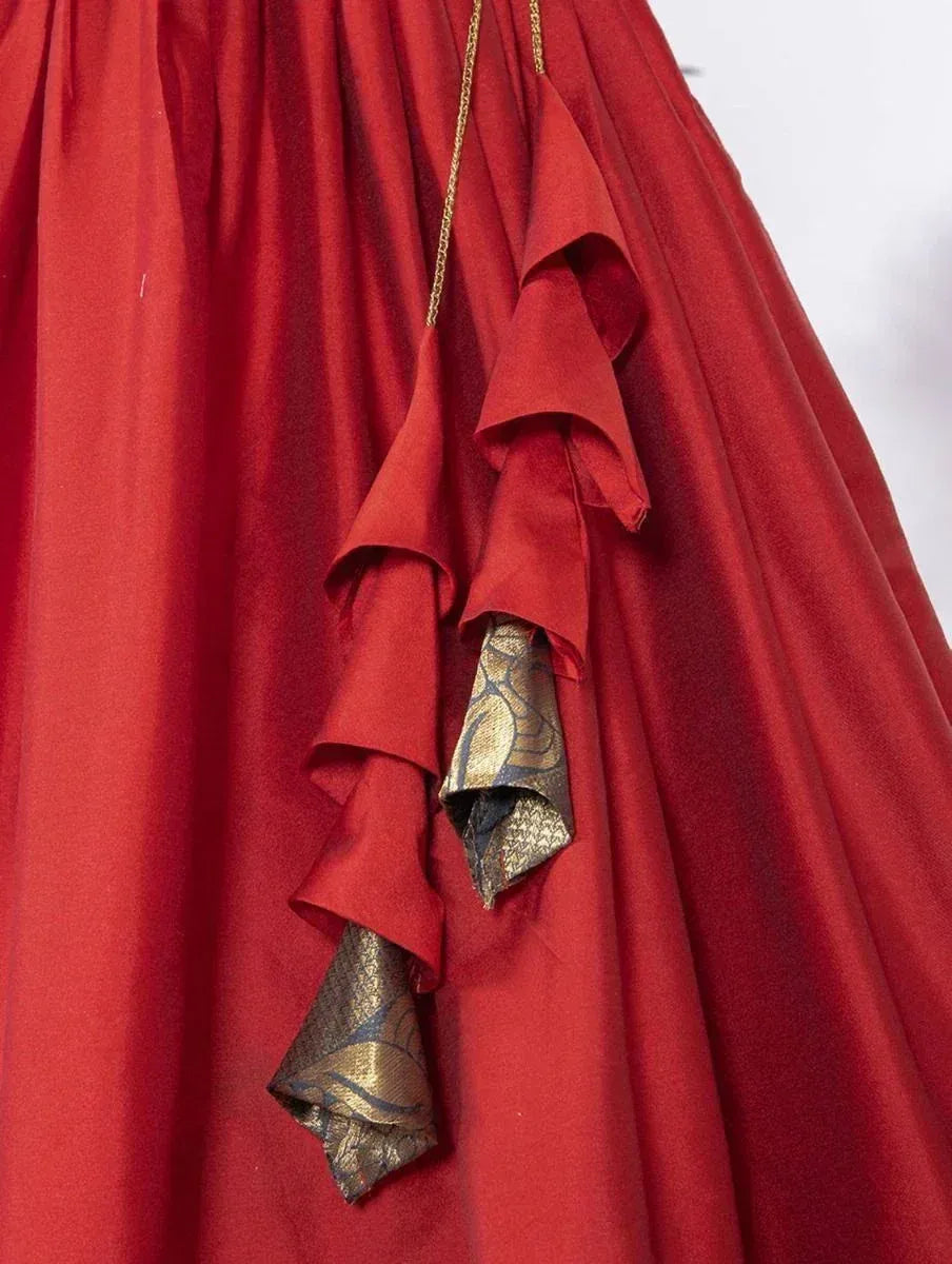 Red ethnic gown with gold ruffle detailing and patterned trim, perfect for festive occasions