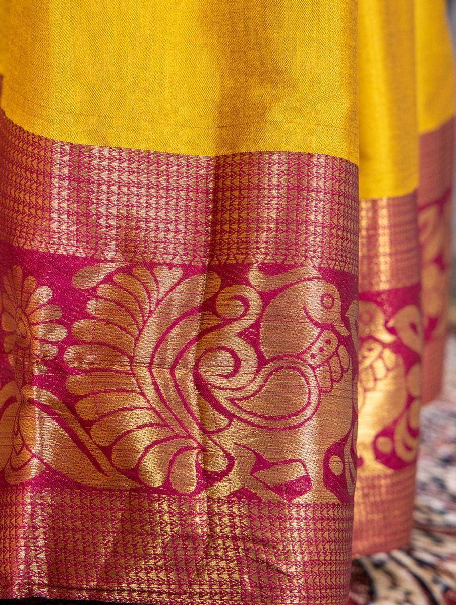 Yellow and pink silk saree with intricate golden zari border and floral motifs, perfect for Indian ethnic wear.