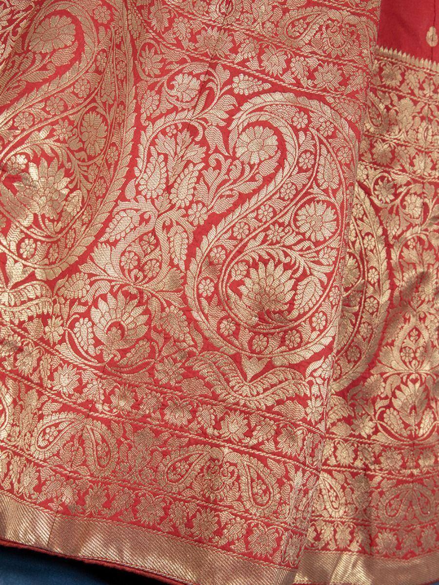 Red and gold brocade saree with intricate floral and paisley embroidery, perfect for Indian ethnic wear.