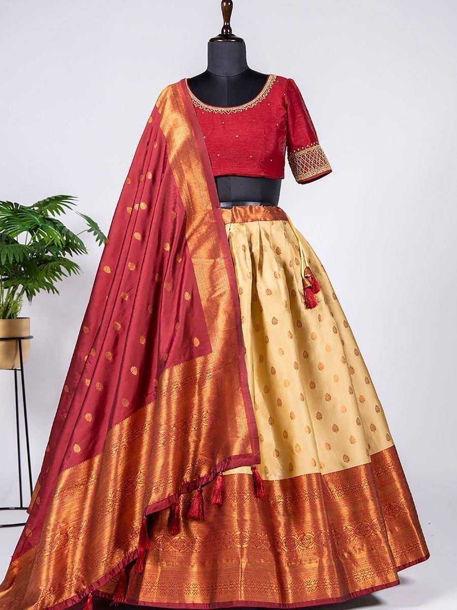 Red and gold designer lehenga choli with embroidered blouse and patterned skirt, perfect for Indian ethnic occasions.