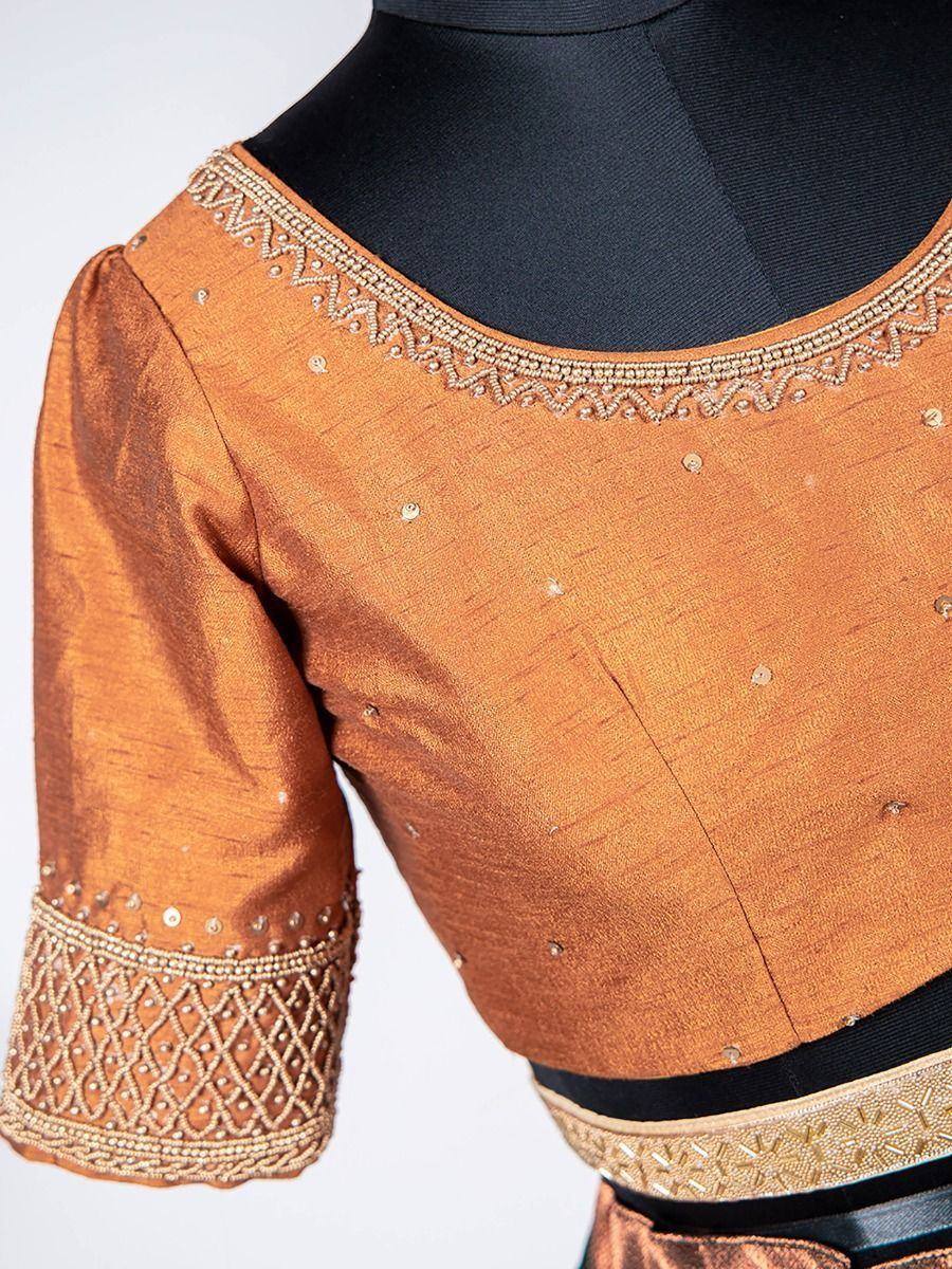 Orange ethnic blouse with gold embroidery and sequins, perfect for lehenga choli or saree