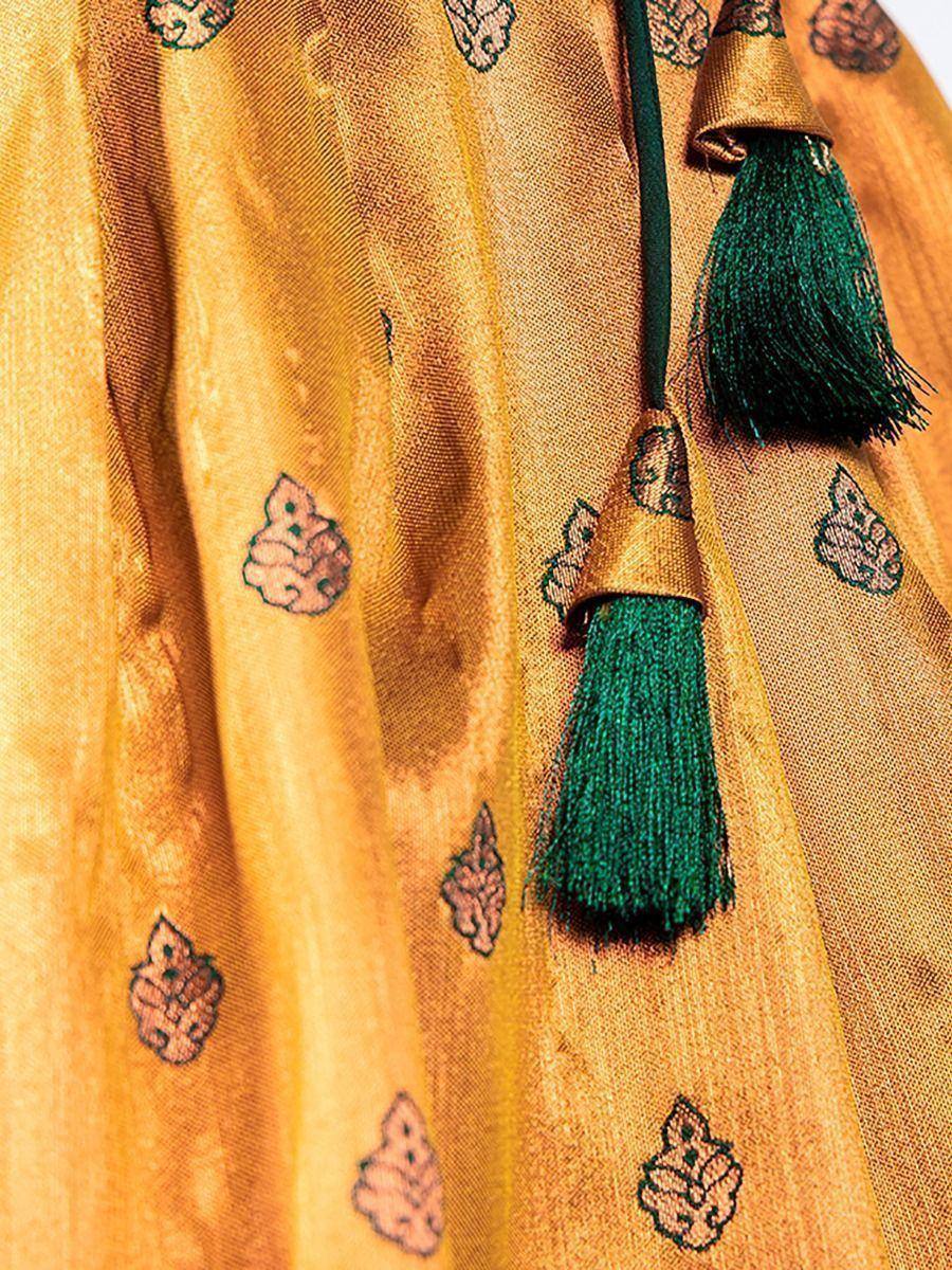 Golden ethnic saree with green tassels and floral motifs, perfect for Indian celebrations