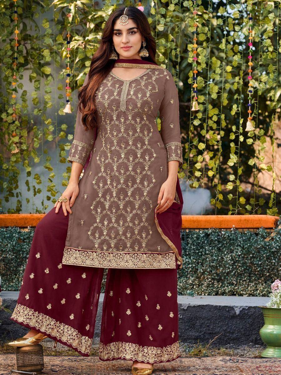 Woman in maroon and beige embroidered salwar kameez with dupatta, outdoor ethnic fashion