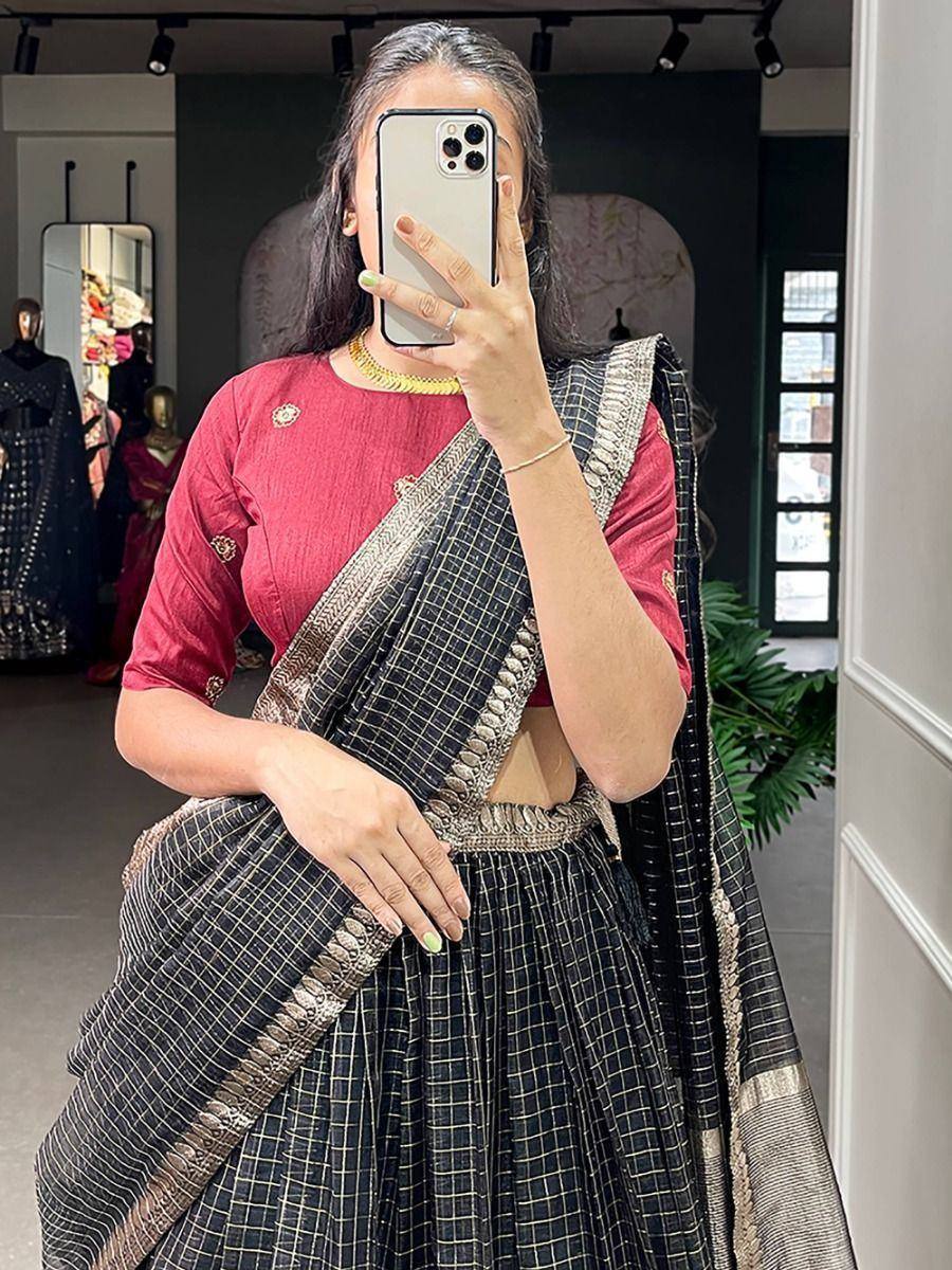 Woman in black checkered saree with gold border and red blouse, ethnic wear