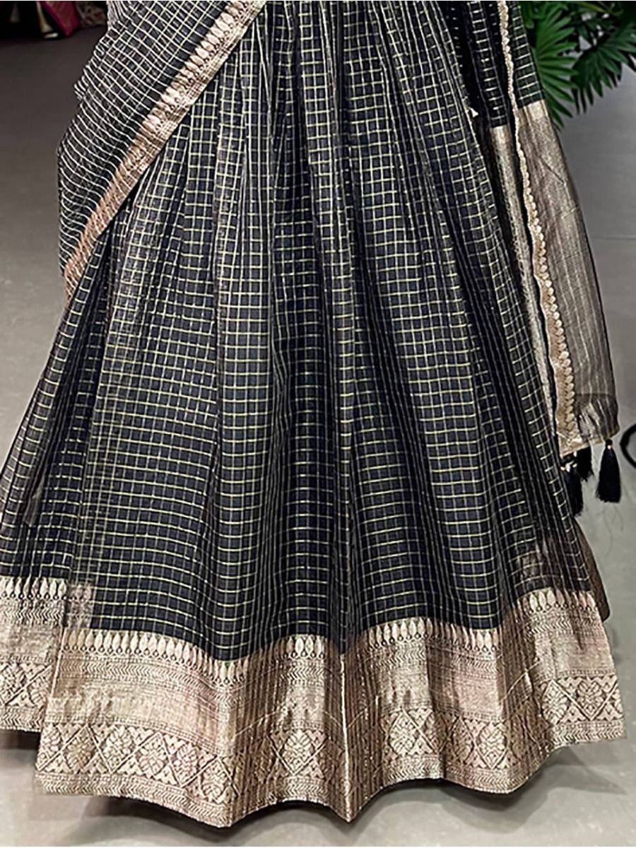 Black and gold checkered lehenga with intricate border detailing, ideal for ethnic occasions