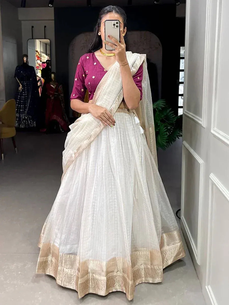 Woman wearing white lehenga with gold border and maroon blouse, Indian ethnic wear