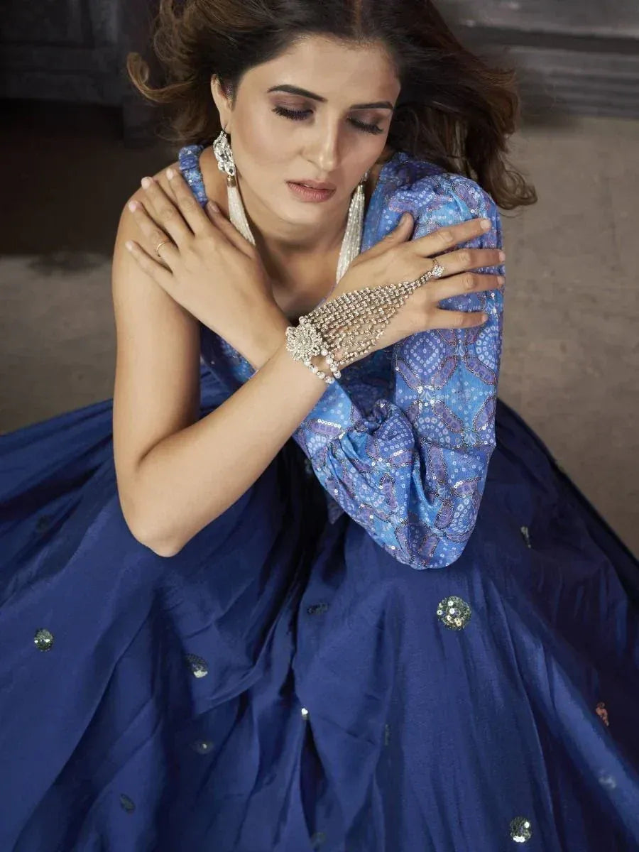 Woman in blue embroidered lehenga choli with statement jewelry, Indian ethnic wear