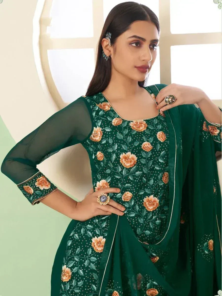 Woman in green floral embroidered ethnic salwar kameez with sheer sleeves