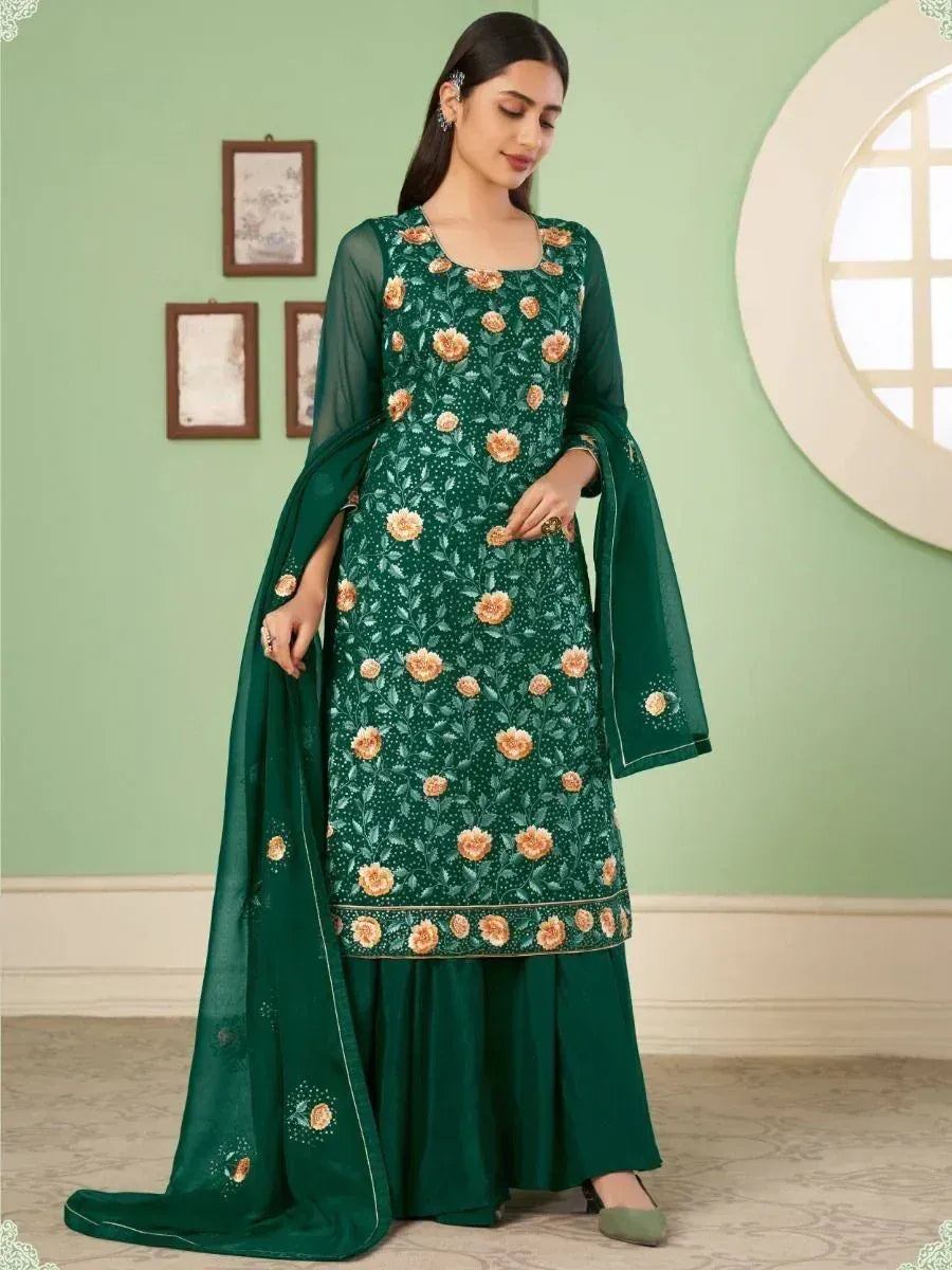 Woman wearing dark green embroidered salwar kameez with peach floral design and matching dupatta