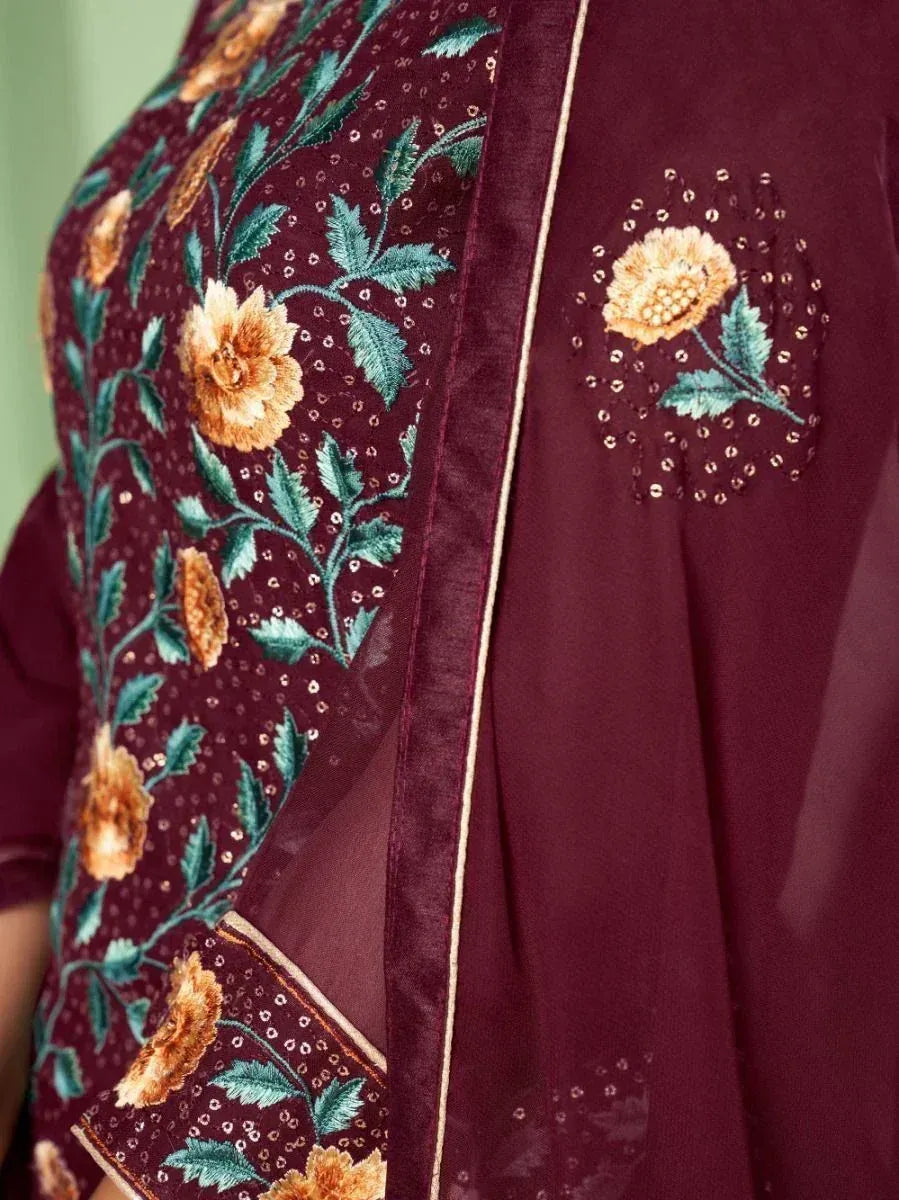 Maroon ethnic wear with floral embroidery and sequin detailing, close-up view