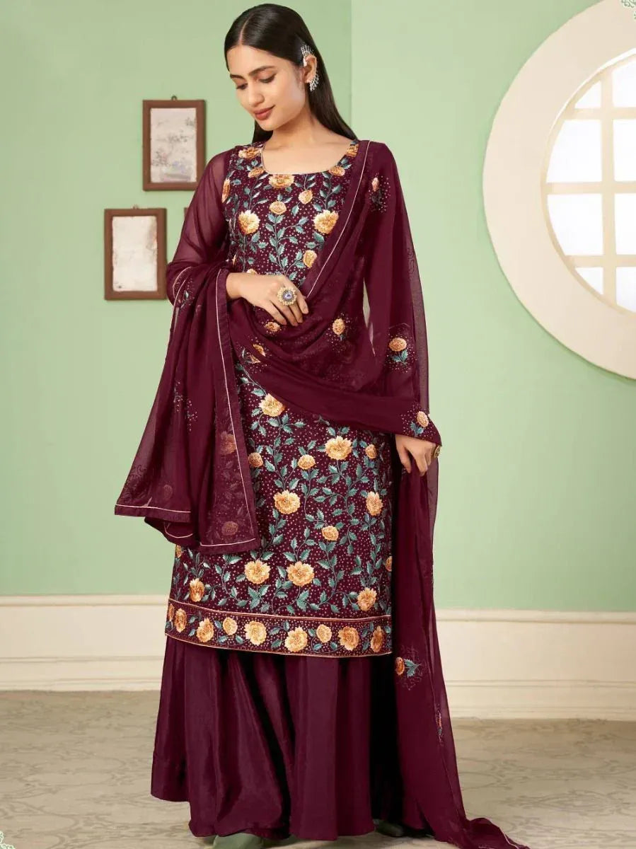 Woman wearing maroon floral embroidered salwar kameez with matching dupatta