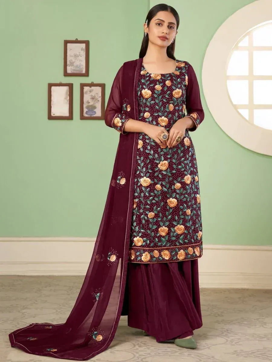 Woman in maroon floral embroidered salwar kameez with dupatta, ethnic Indian attire