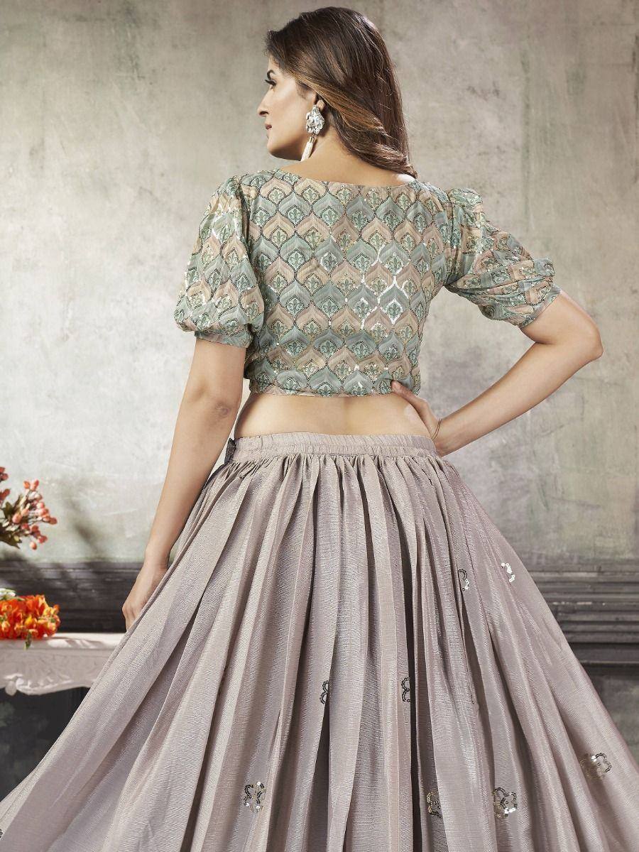 Elegant Indian lehenga choli with embroidered crop top and pleated skirt, perfect for festive occasions.