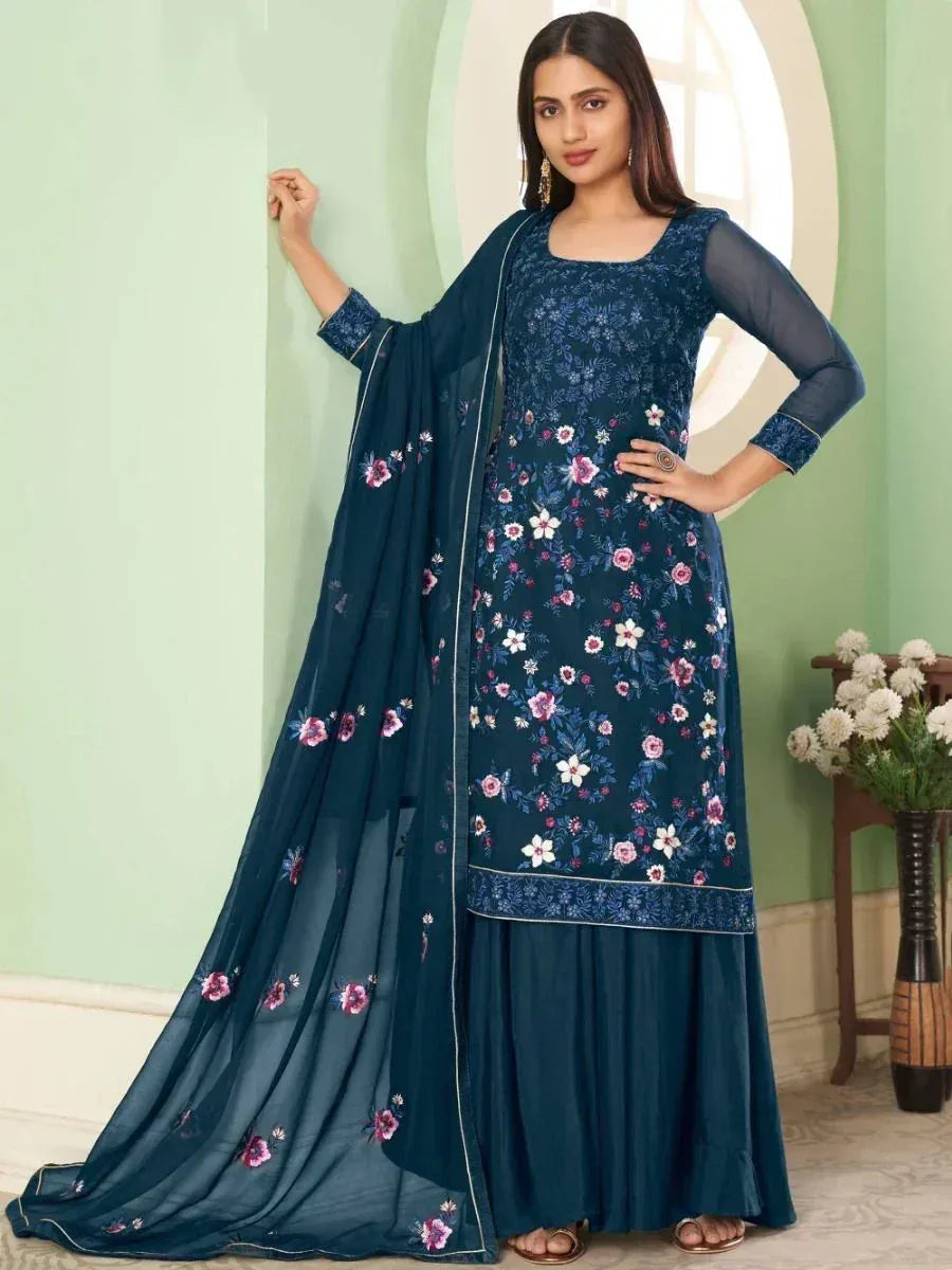 Woman wearing a navy blue floral embroidered salwar kameez with matching dupatta
