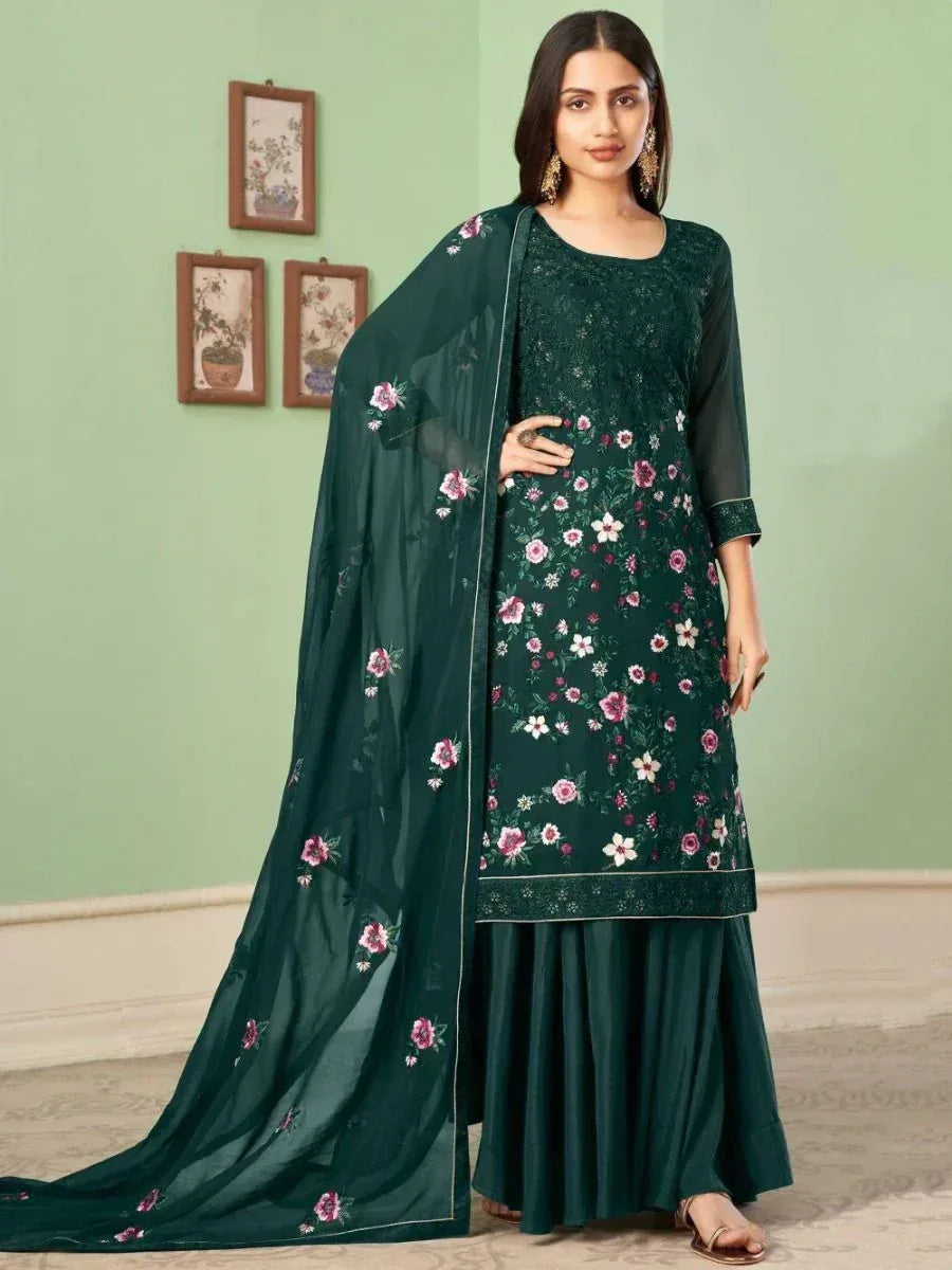 Woman in dark green floral embroidered salwar kameez with matching sheer dupatta