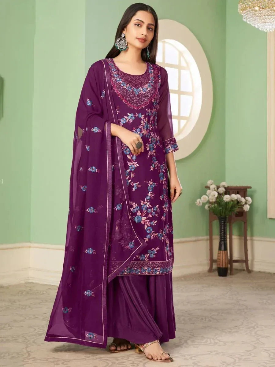 Woman in purple floral embroidered salwar kameez with dupatta, traditional Indian outfit