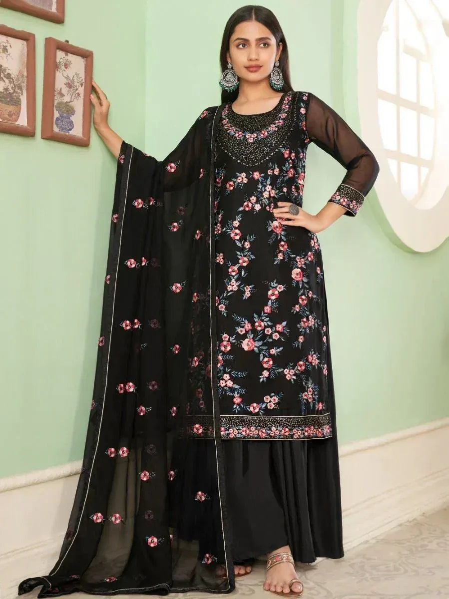 Woman wearing black floral embroidered salwar kameez with dupatta, traditional Indian attire