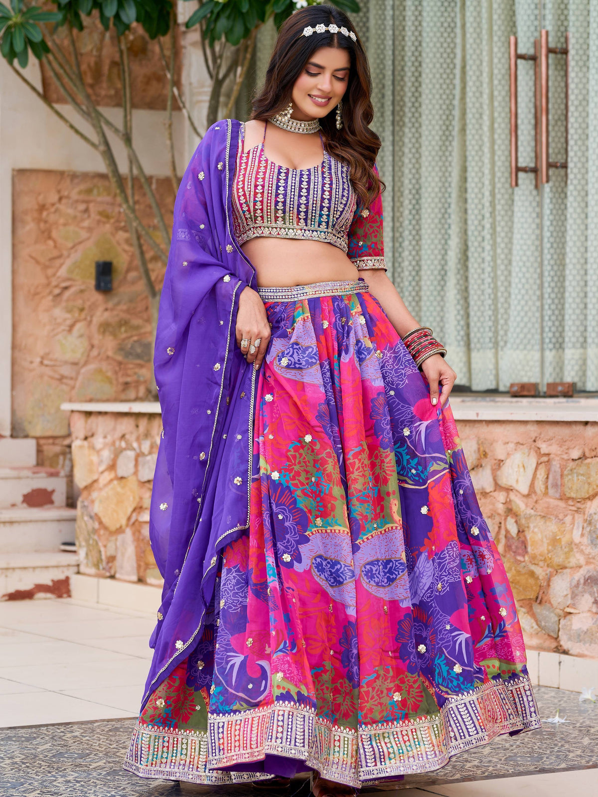 Vibrant purple and pink floral lehenga choli with embroidered blouse and dupatta, perfect for Indian ethnic wear