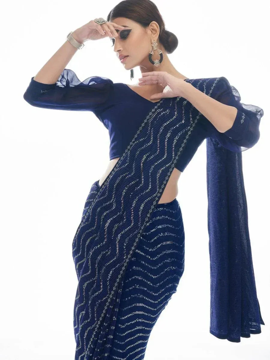 Navy blue saree with silver wave embroidery, sheer sleeves, and modern blouse for Indian ethnic wear