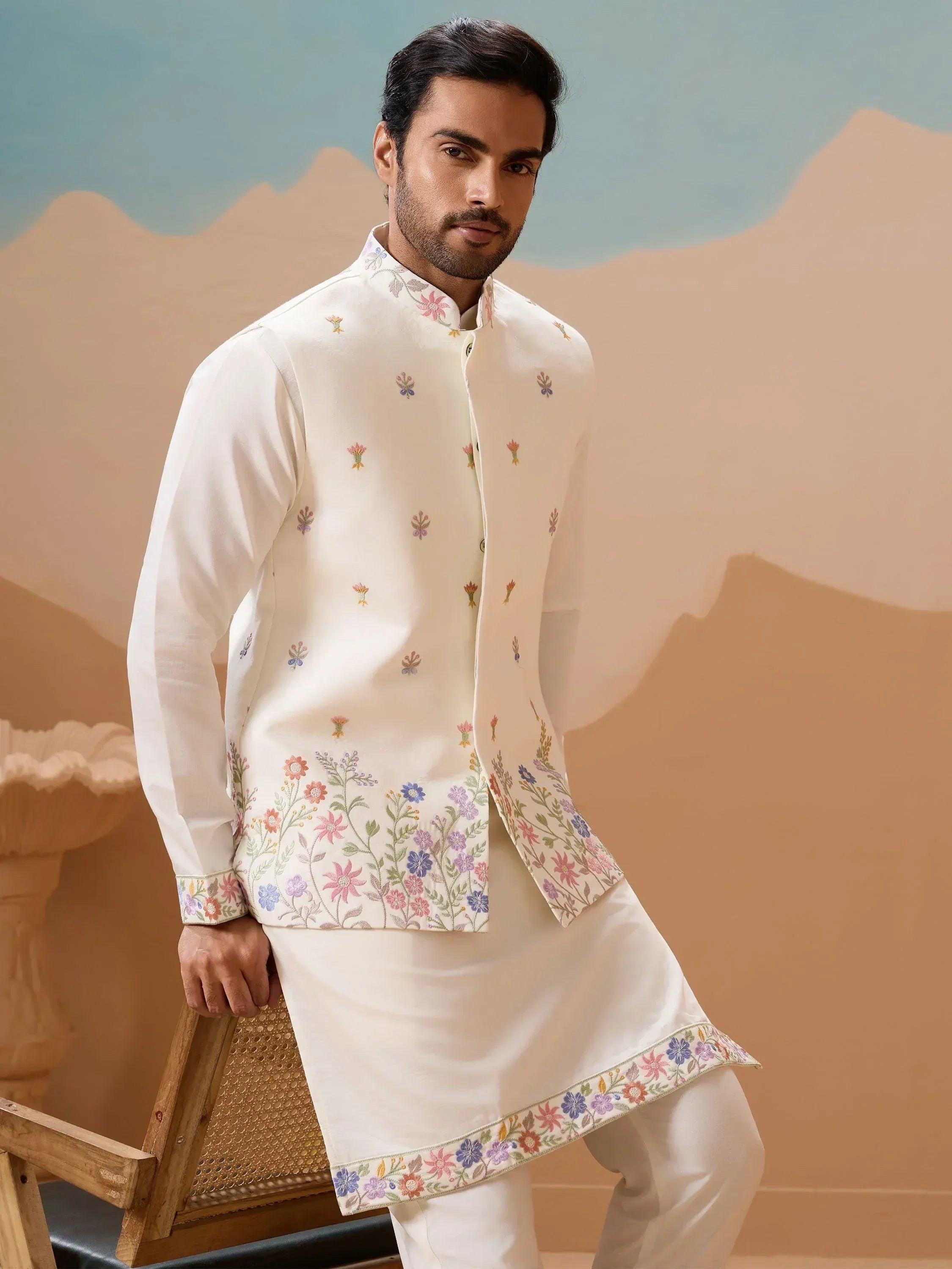 Men's white kurta with colorful floral embroidery, perfect for ethnic occasions and festive wear.