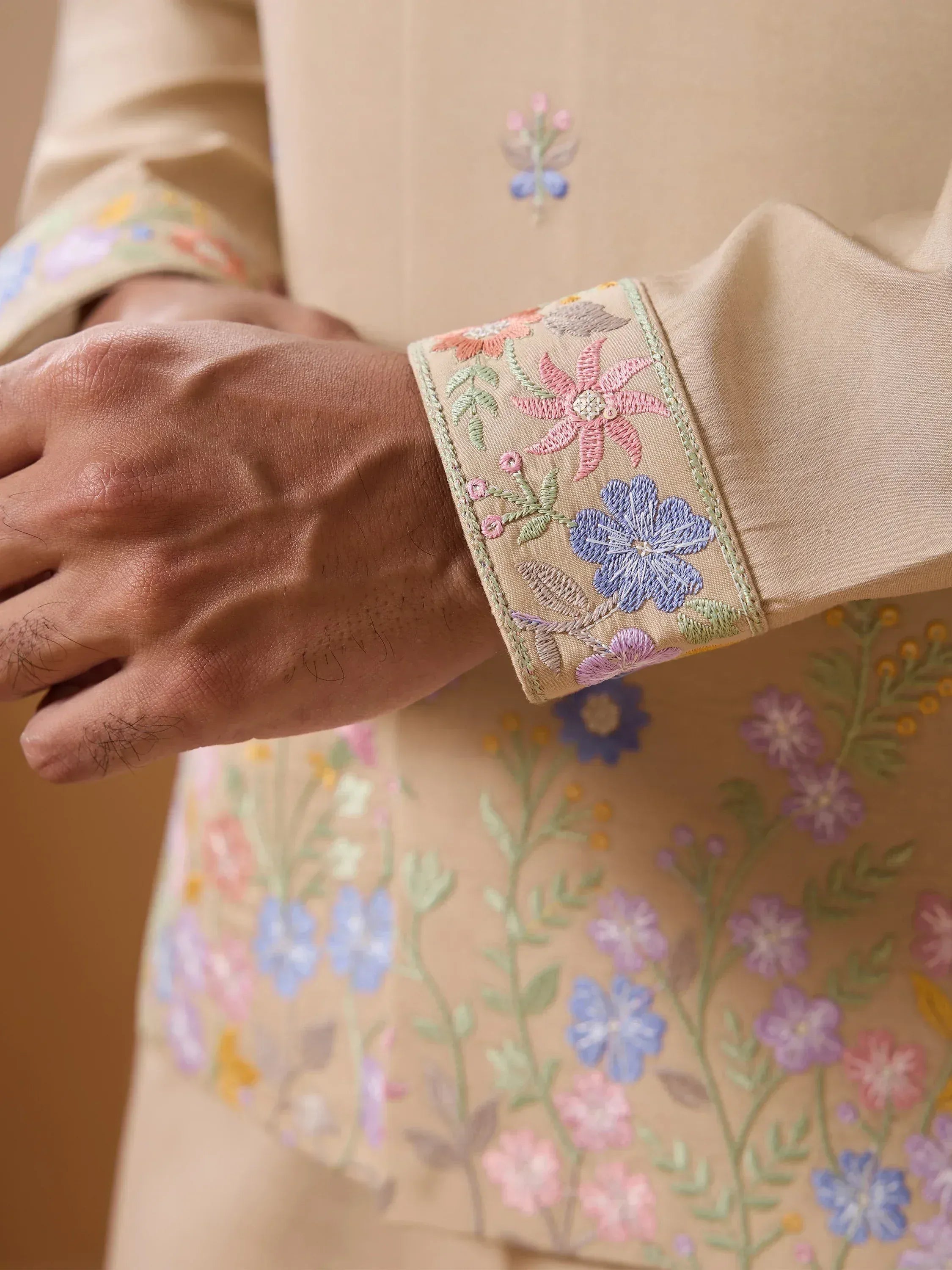 Beige kurta with colorful floral embroidery on sleeves and chest, ethnic wear design