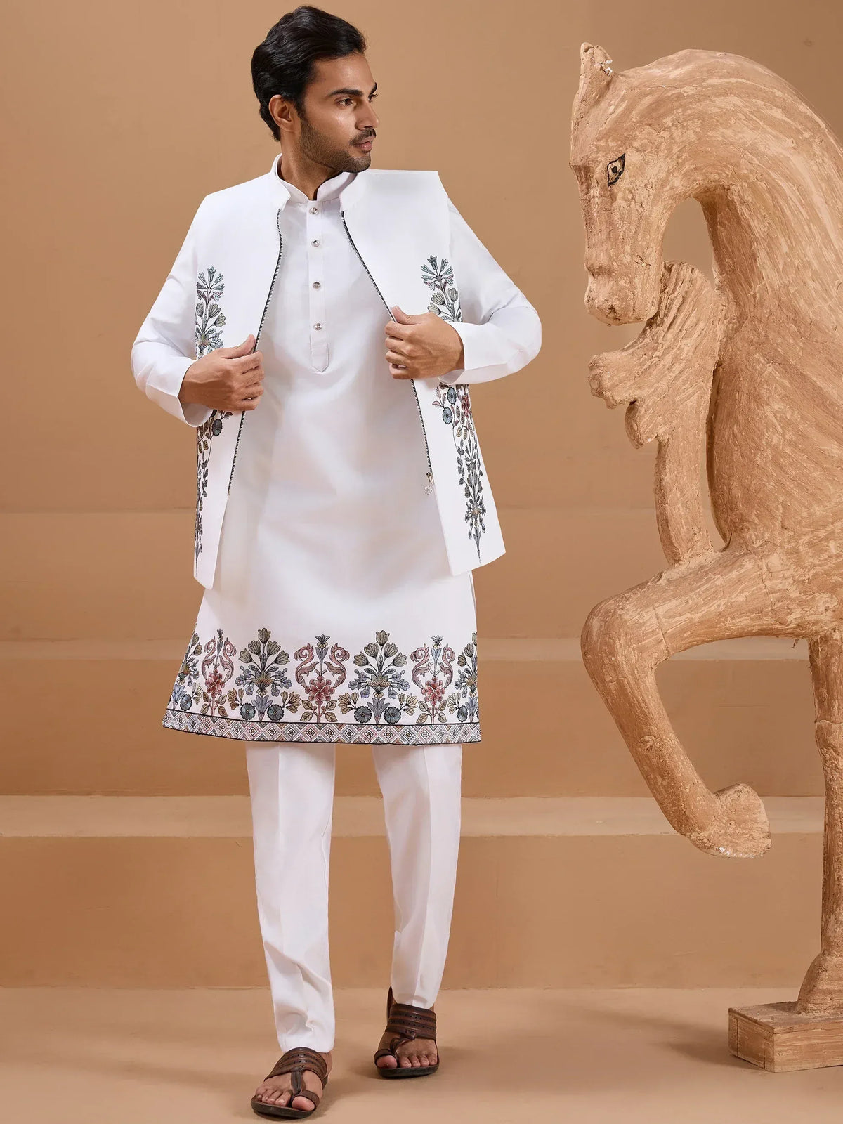 Man in white embroidered kurta set with floral details, styled for Indian ethnic wear occasions