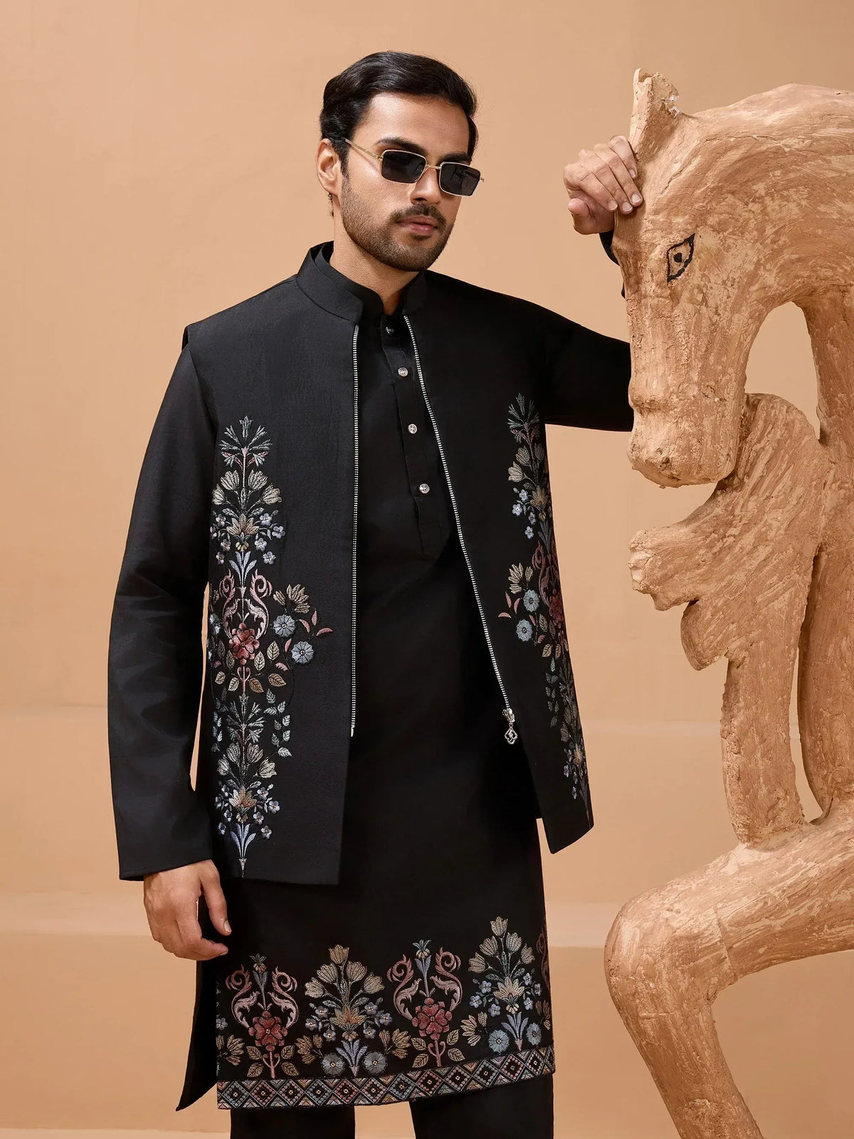 Man in black embroidered kurta set with floral design, stylish ethnic wear for men