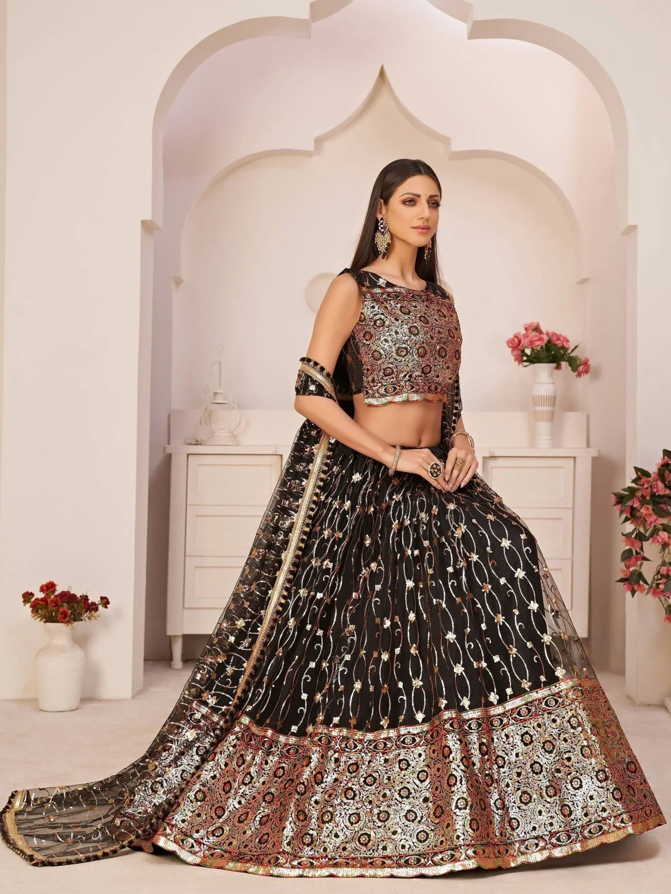 Black embroidered lehenga choli with gold detailing, perfect for Indian weddings and festive occasions.
