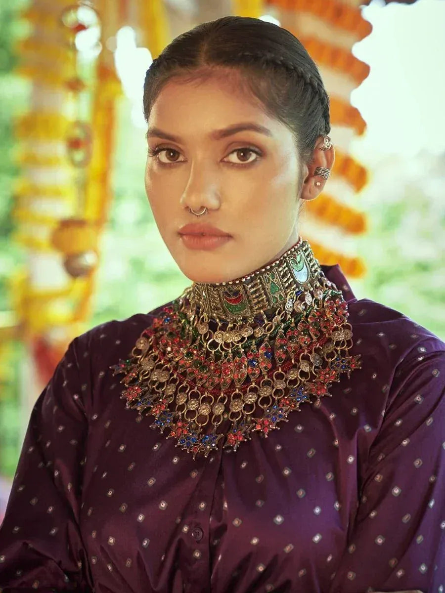 Woman in purple ethnic blouse with ornate jewelry, perfect for Indian festive wear