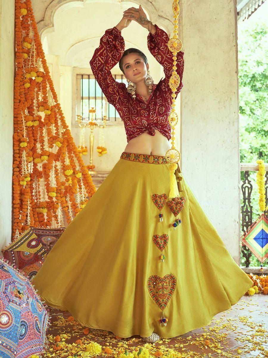 Woman in maroon embroidered blouse and yellow lehenga with heart motifs, festive Indian ethnic wear