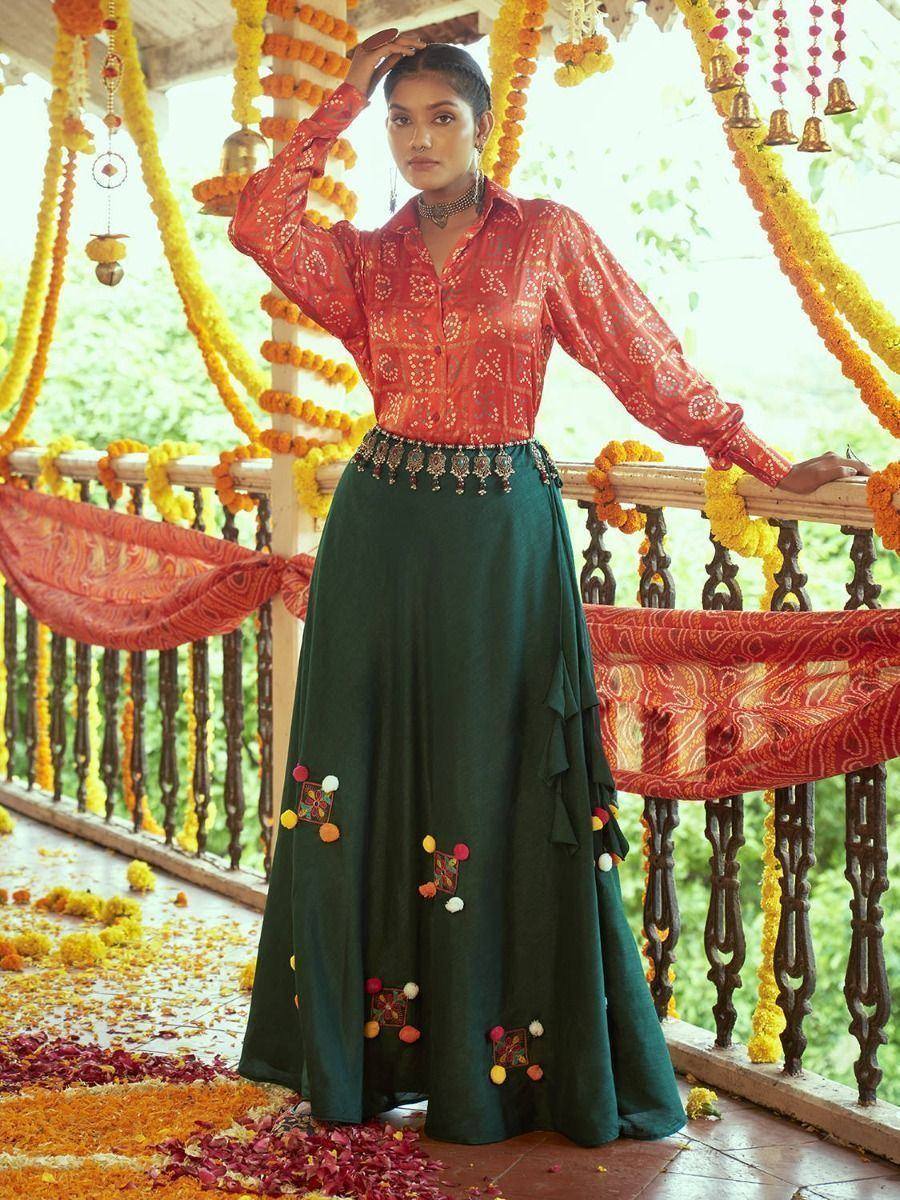 Woman in red printed blouse and green embroidered skirt, festive Indian ethnic wear
