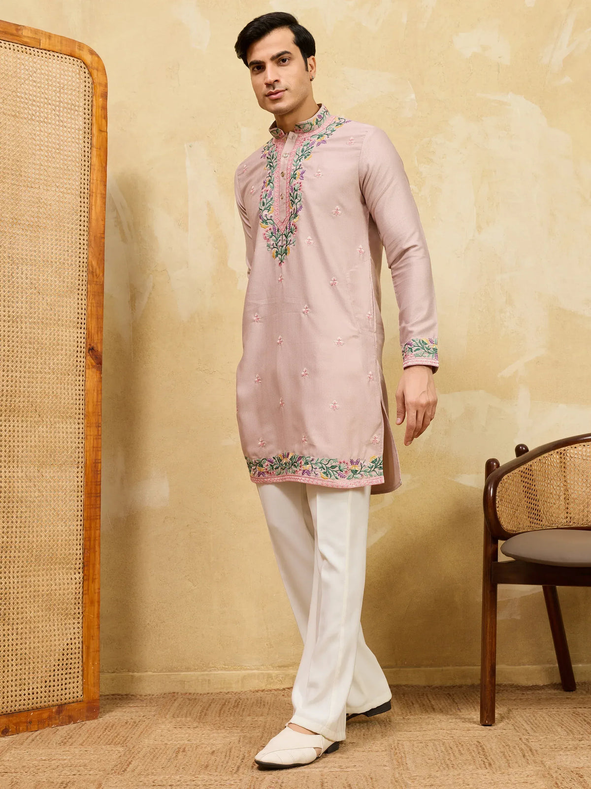 Man wearing a pink embroidered kurta with white pajamas
