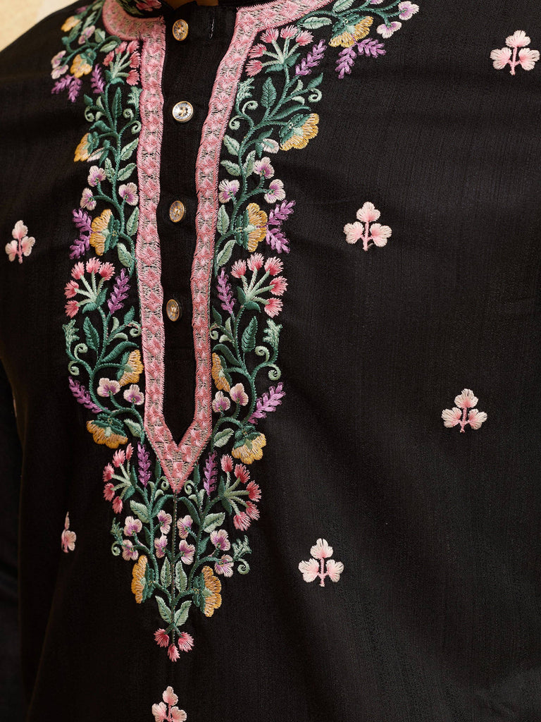 Close-up of black ethnic kurta featuring intricate floral embroidery on the placket