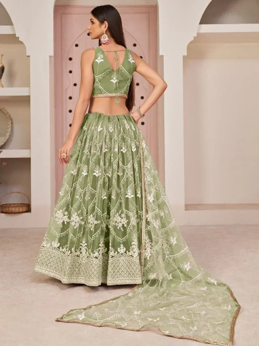 Green embroidered lehenga choli with floral motifs and sheer dupatta, perfect for Indian ethnic occasions