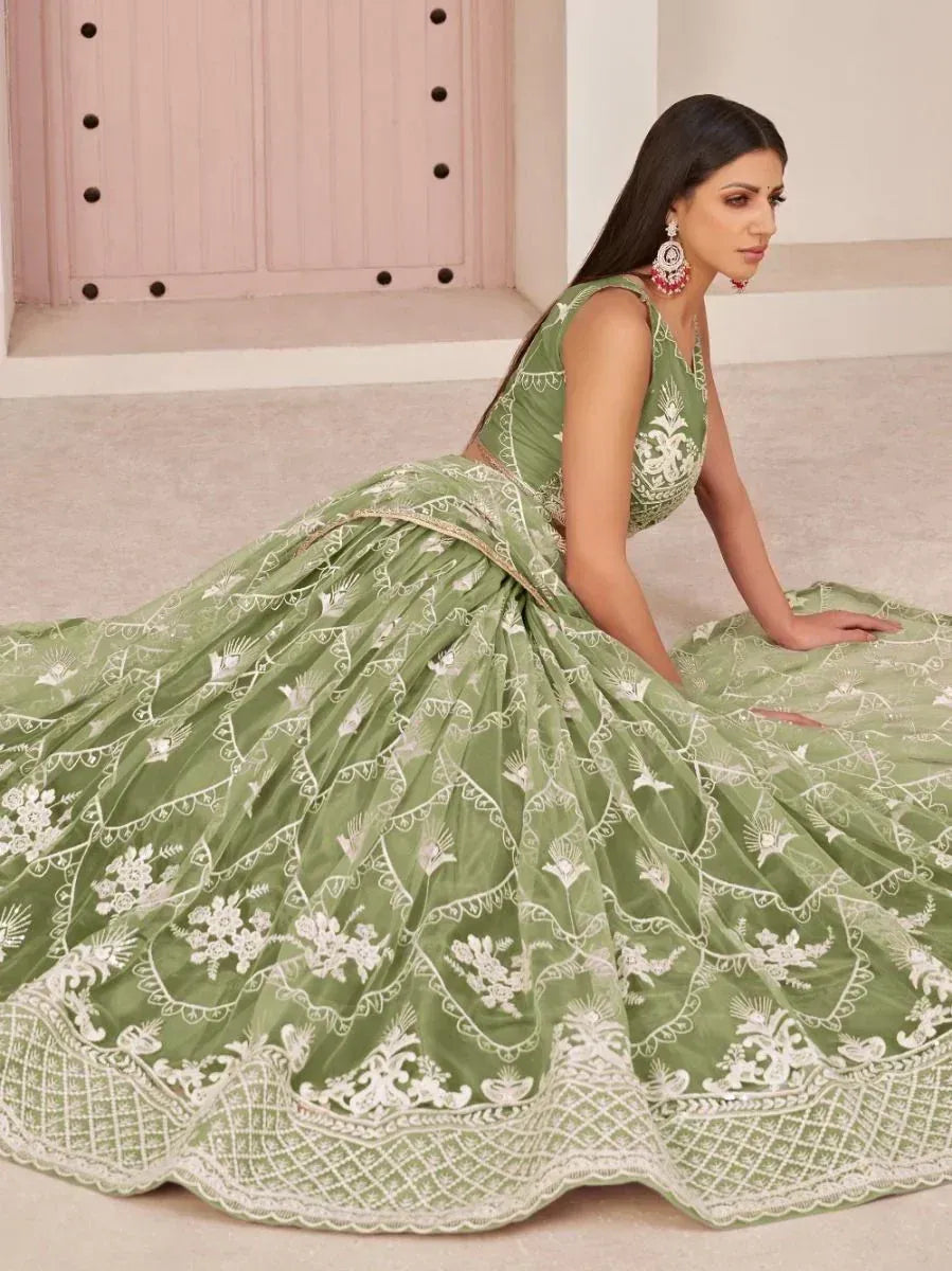 Green embroidered lehenga choli with white floral motifs, perfect for Indian ethnic occasions