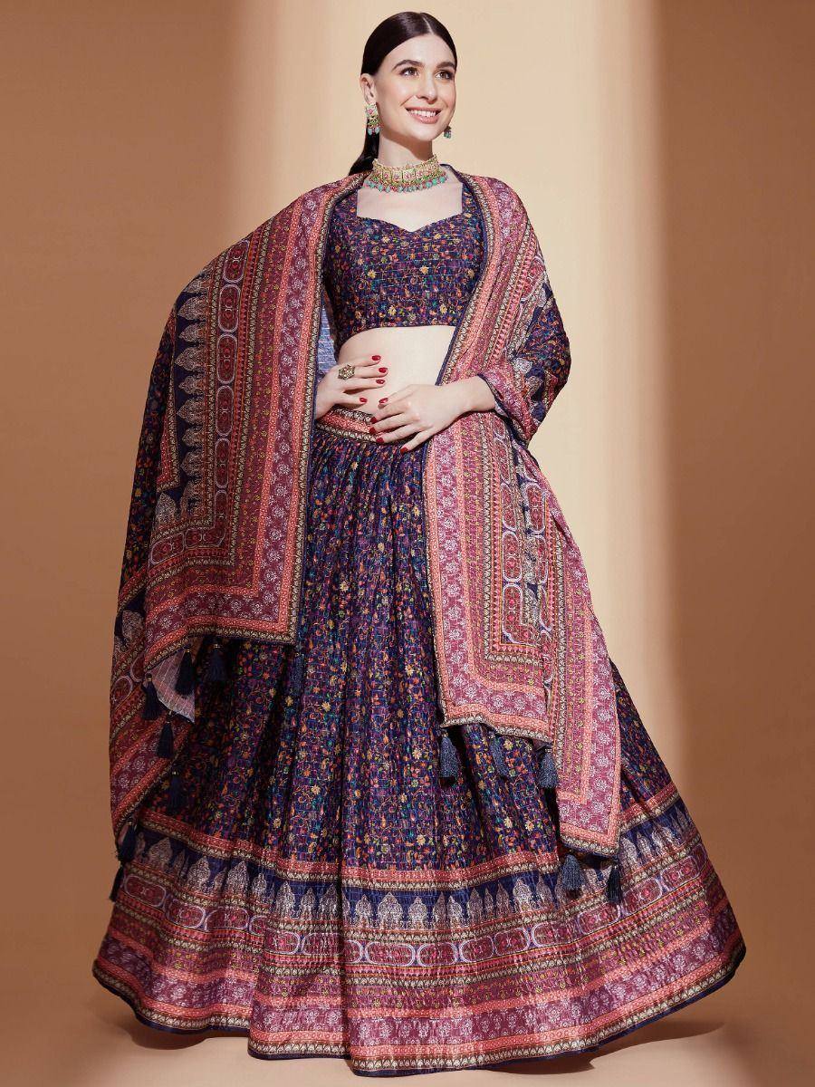 Woman in designer lehenga choli with intricate floral print and embroidered dupatta, perfect for Indian ethnic occasions.