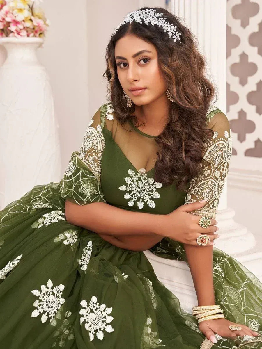 Elegant green lehenga choli with white floral embroidery and matching jewelry
