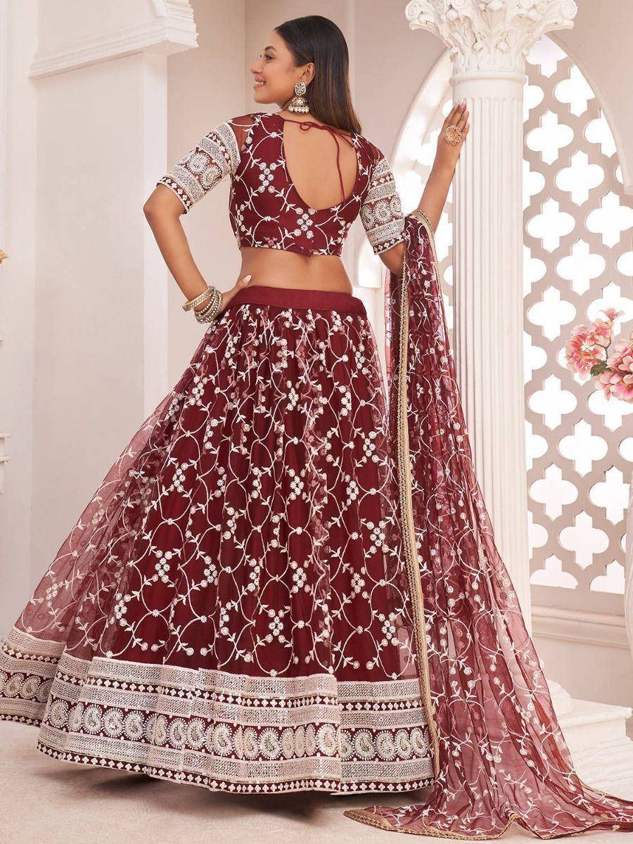 Maroon embroidered lehenga choli with floral motifs, perfect for Indian weddings and festive occasions.