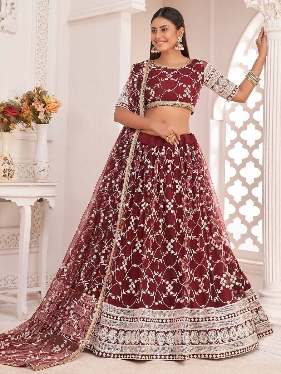 Maroon embroidered lehenga choli with floral motifs, perfect for Indian weddings and festive occasions.