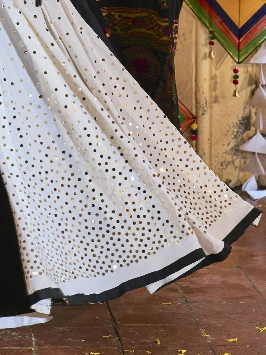 White ethnic skirt with gold mirror work and black trim, perfect for Indian festive wear