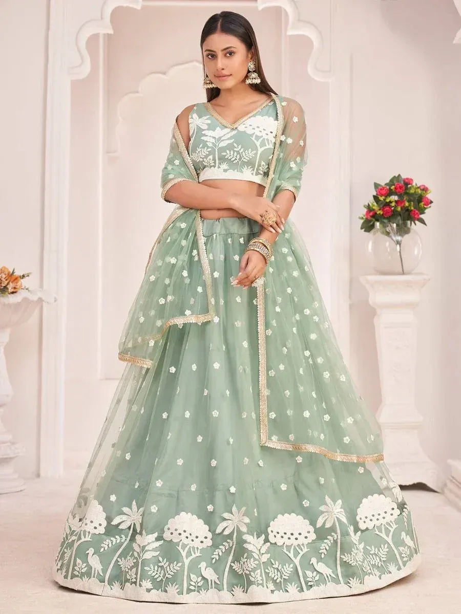 Mint green lehenga choli with white floral embroidery and gold trim, perfect for Indian ethnic occasions