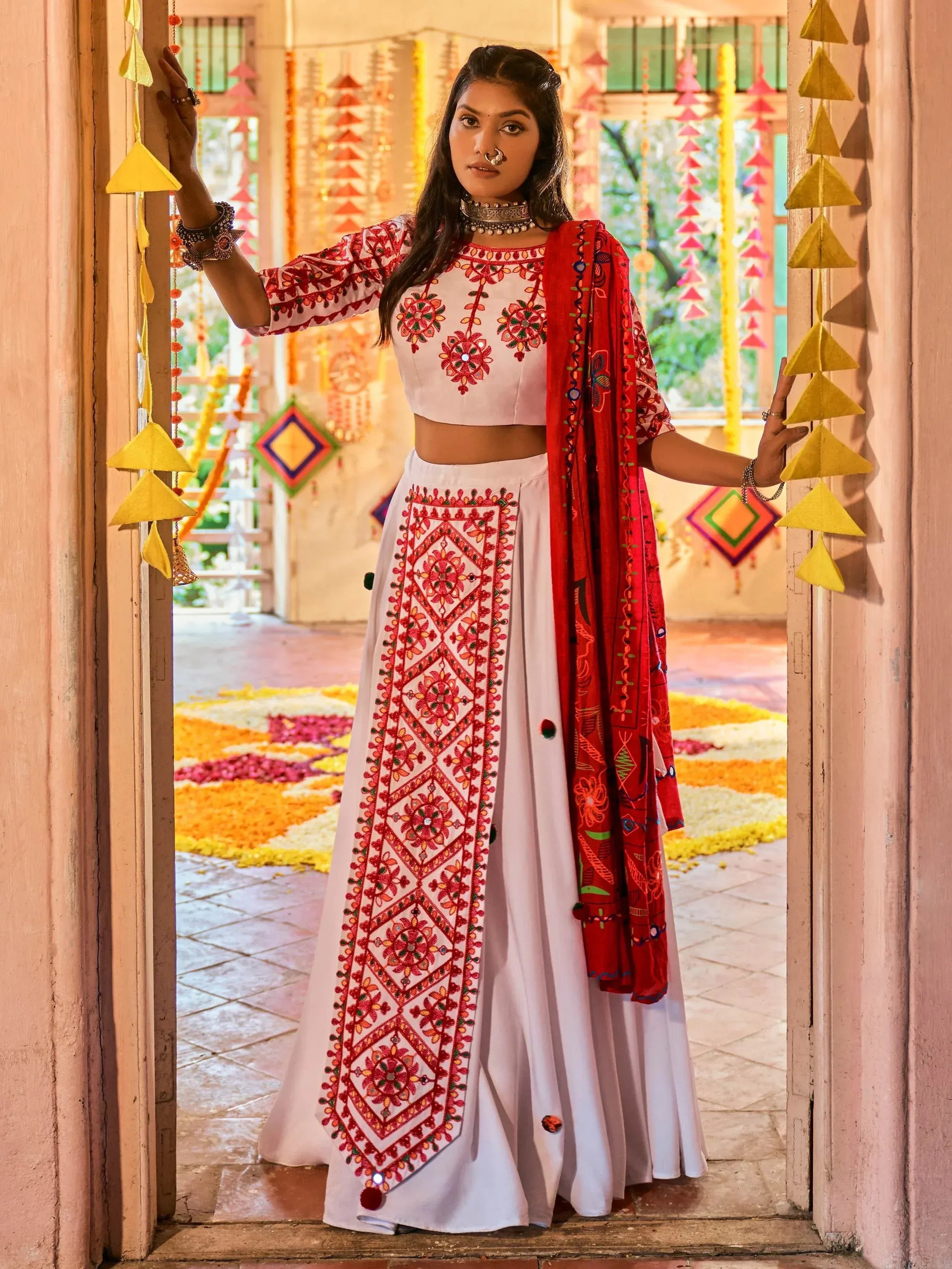 White and red embroidered ethnic wear with mirror work, perfect for festive occasions and celebrations.