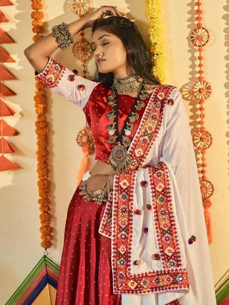Red and white embroidered lehenga choli with mirror work, perfect for Indian ethnic occasions