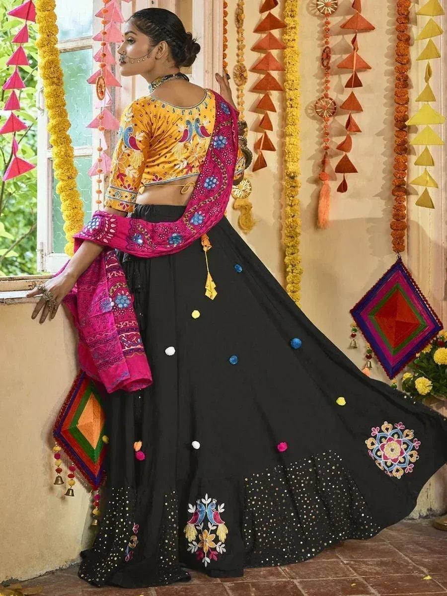 Black embroidered lehenga with yellow blouse and pink dupatta, festive Indian ethnic wear