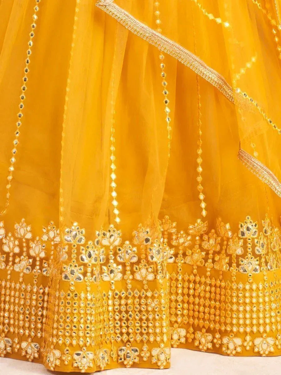 Yellow lehenga with intricate mirror and gold embroidery, perfect for Indian ethnic wear