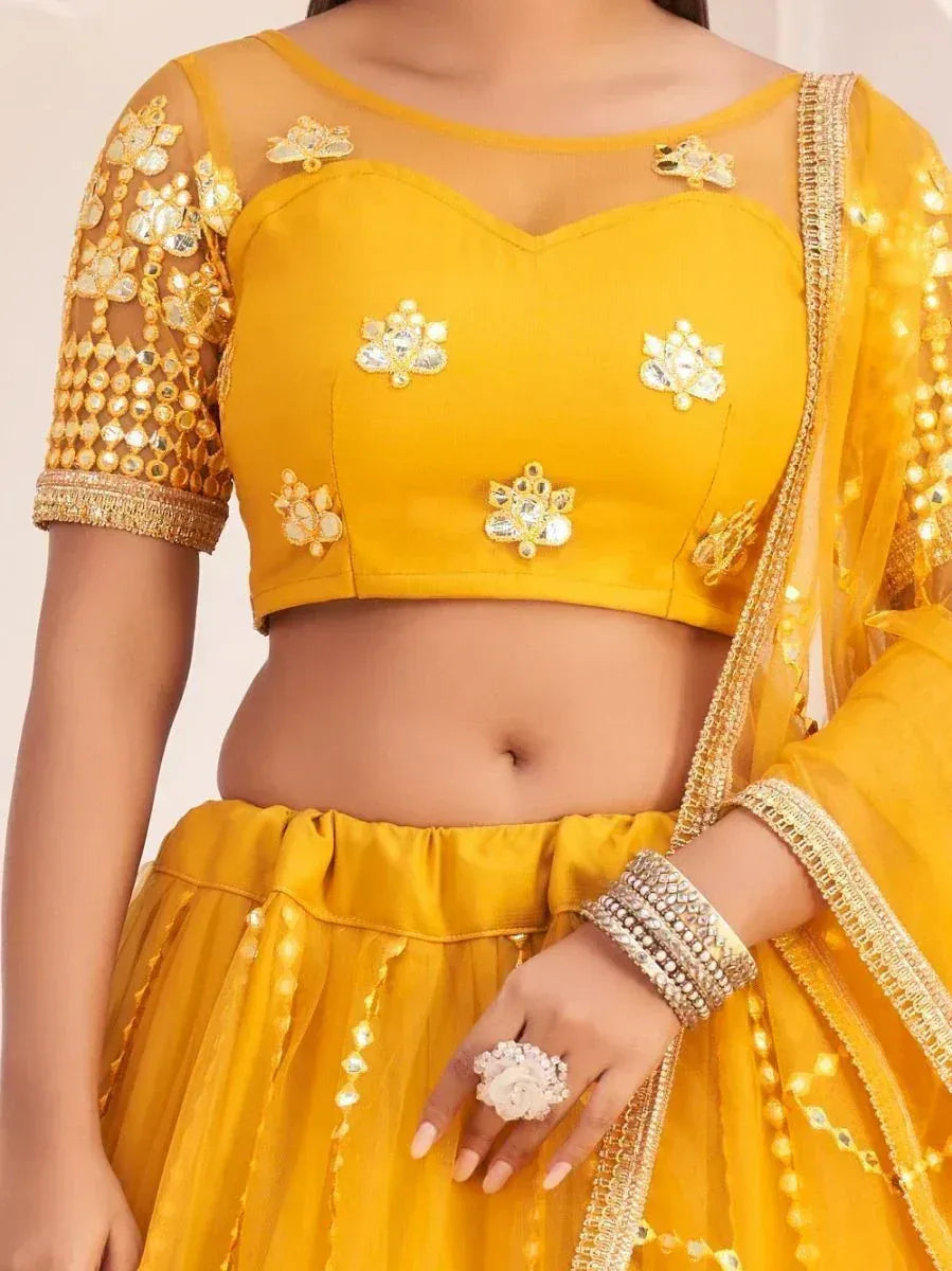 Yellow designer lehenga choli with gold embroidery and mirror work, perfect for ethnic occasions