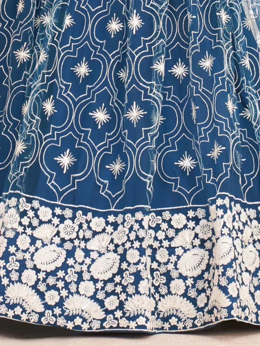 Blue ethnic lehenga skirt with white floral and geometric embroidery, perfect for Indian weddings and festivals.