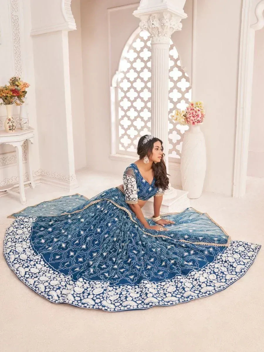 Blue designer lehenga choli with white embroidery, perfect for Indian weddings and ethnic events
