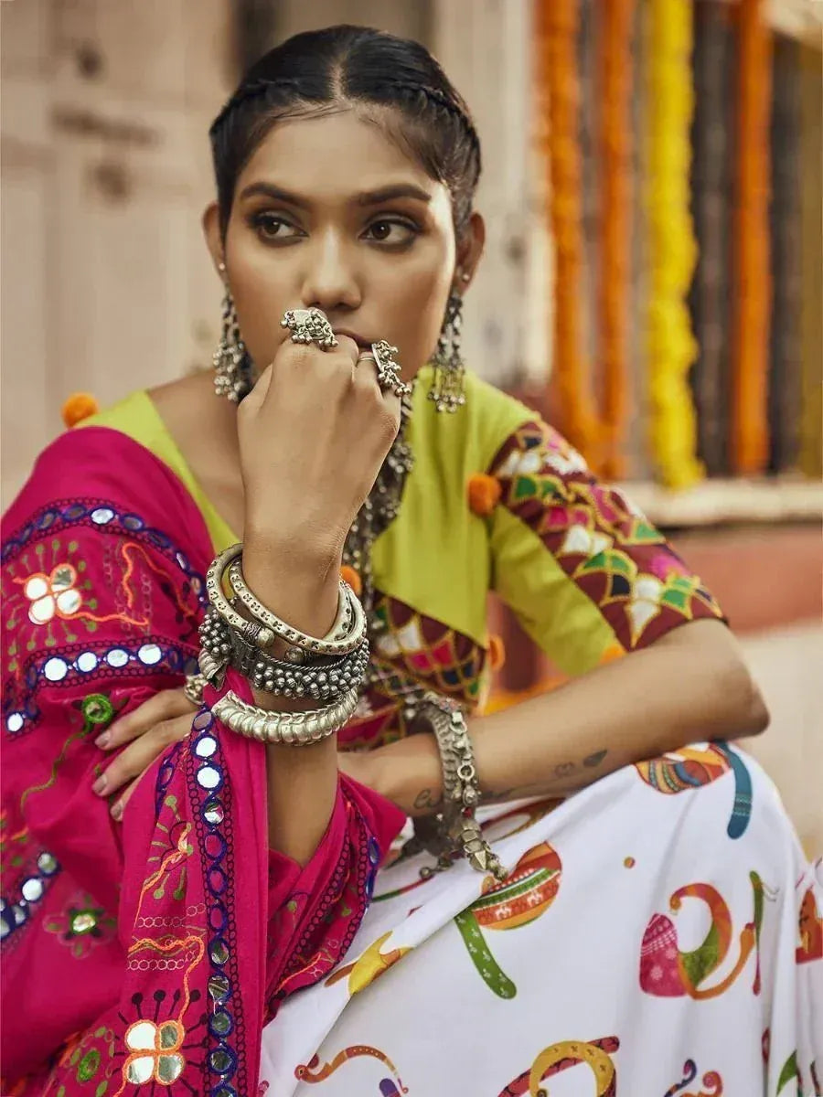 Woman in colorful Indian ethnic wear with mirror work, bangles, and traditional jewelry